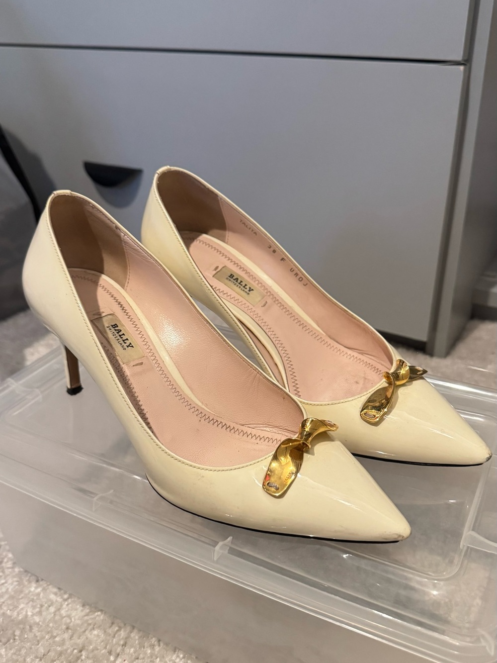 Bally Cream Patent Leather Pointed Pumps with Gold Bow Accent